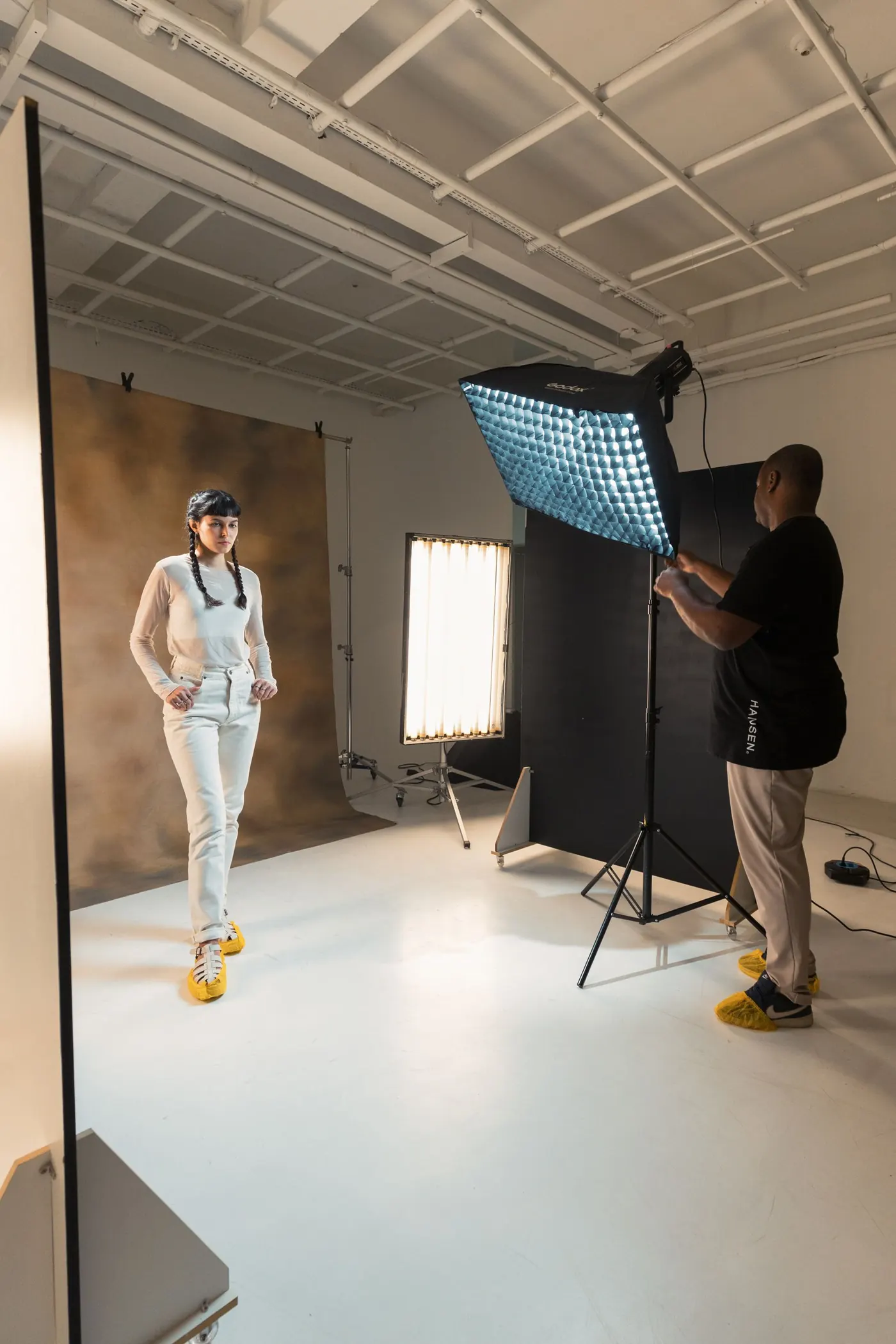 Photographer and model working on an editorial studio set